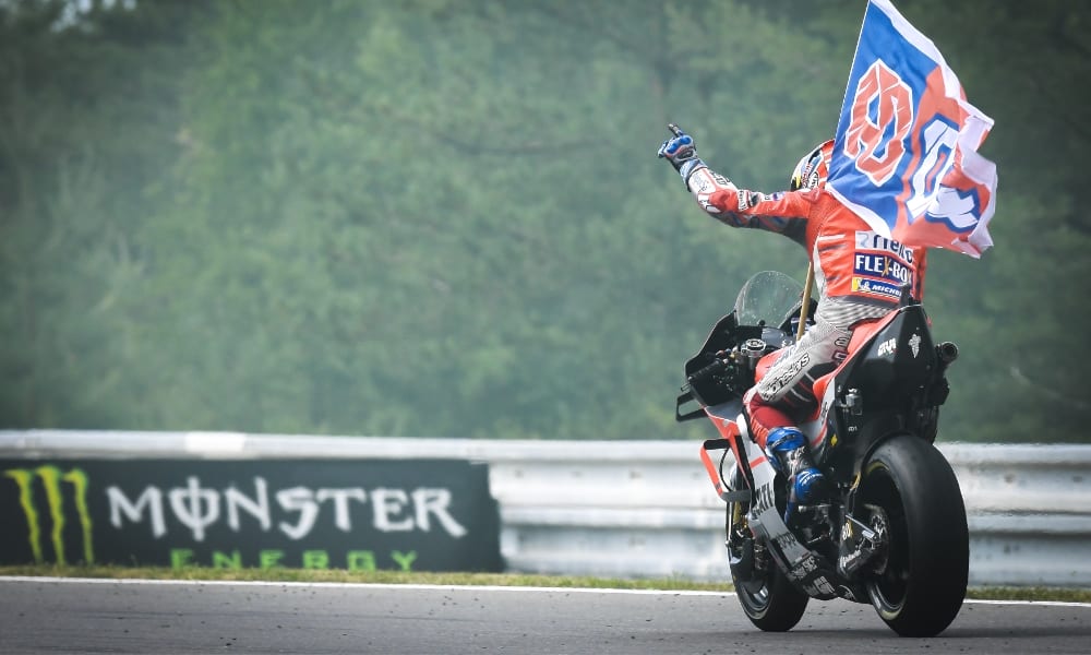 Flying the flag: Dovizioso celebrates on his victory lap (Pic: MotoGP)